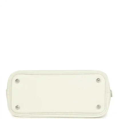 Hermes white mini Bolide bag bottom view with four metal feet and stitched edges