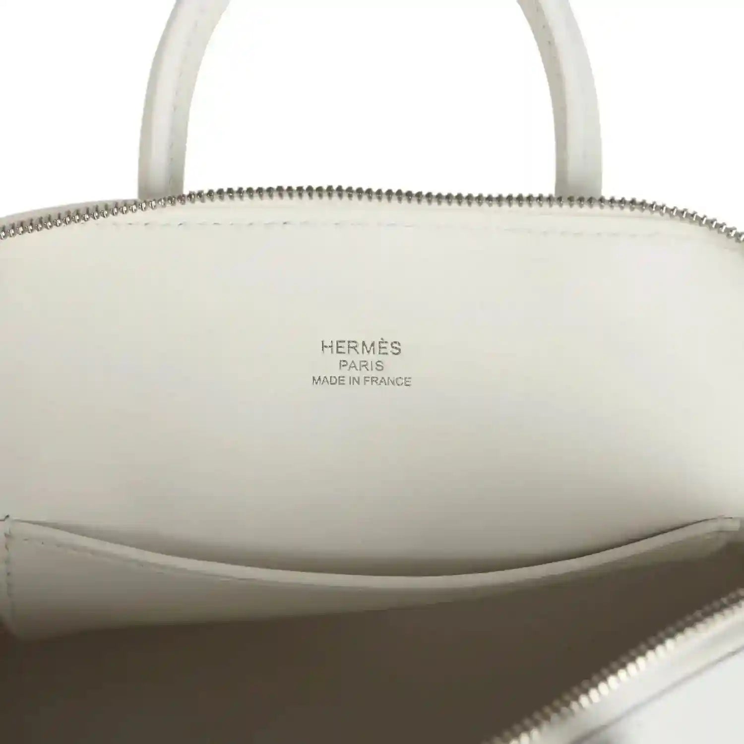 Hermes mini Bolide bag interior view with engraved brand text on the lining