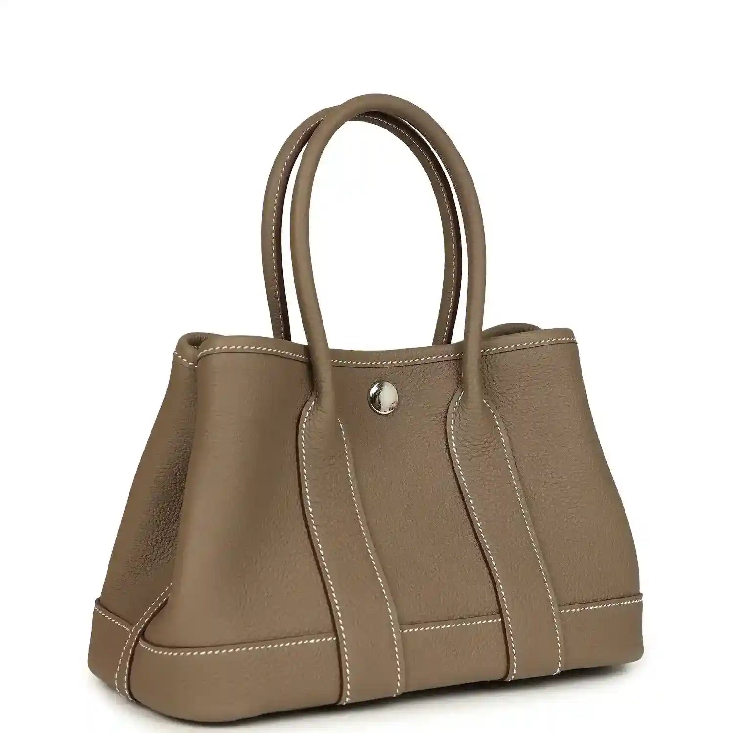 Taupe leather mini tote bag with top handles, front snap closure, and stitched panel detailing