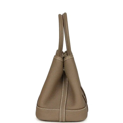 Taupe leather mini tote bag with tall handles and side stitched seams