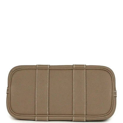 Taupe leather mini tote bag with flat base, stitched panels, and top zipper edge