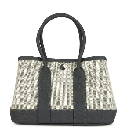 Hermes Garden Party Neo 23 tote in ecru canvas with dark leather trim and handles