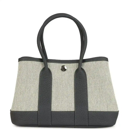 Hermes Garden Party Neo 23 tote in ecru canvas with dark leather trim and handles