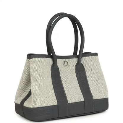 Hermes Garden Party Neo 23 tote with ecru woven canvas and dark leather paneling