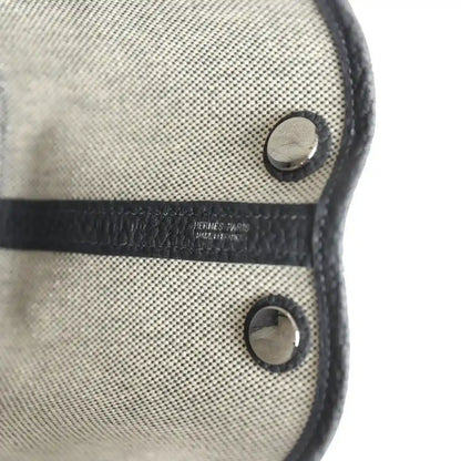 Hermes Garden Party Neo 23 tote front with dark snaps and stamped leather trim