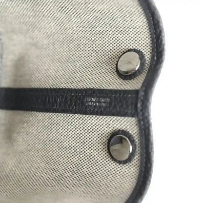 Hermes Garden Party Neo 23 tote front with dark snaps and stamped leather trim