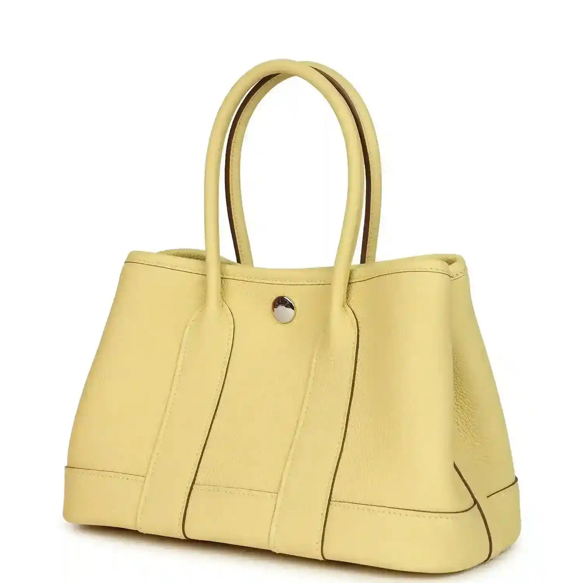 Yellow leather tote bag with curved top handles and front snap button, seam detailing