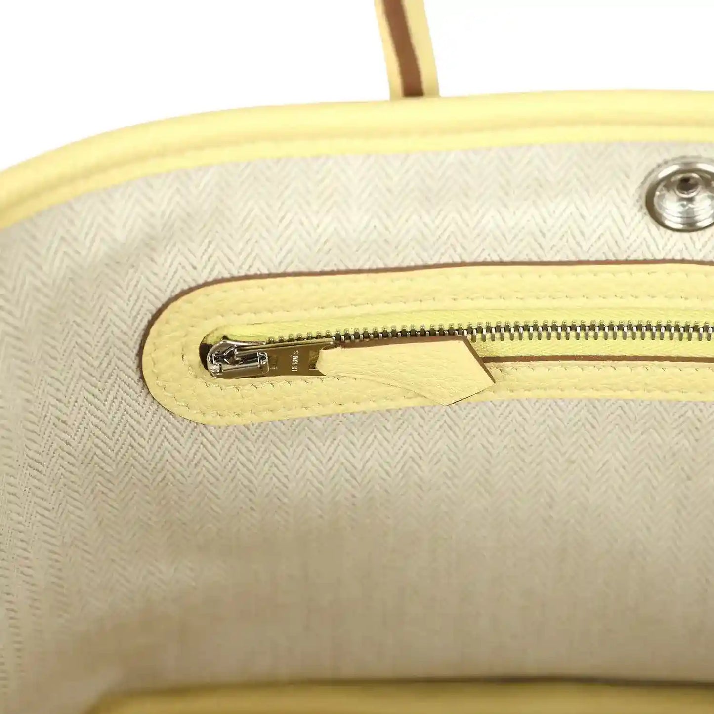 Yellow leather bag interior with zip pocket and silver-tone zipper pull