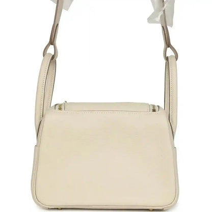 Hermes mini Lindy II bag, pale cream leather, top seam and handles, front view