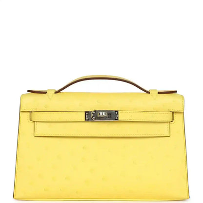 Yellow leather Kelly-style pochette with top handle, front flap and silver-tone lock