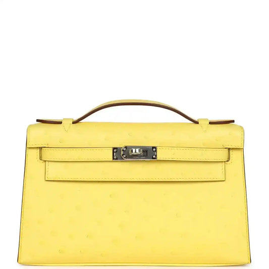 Yellow leather Kelly-style pochette with top handle, front flap and silver-tone lock
