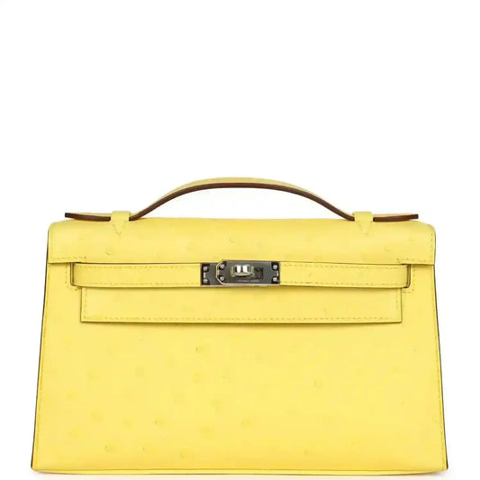 Yellow leather Kelly-style pochette with top handle, front flap and silver-tone lock