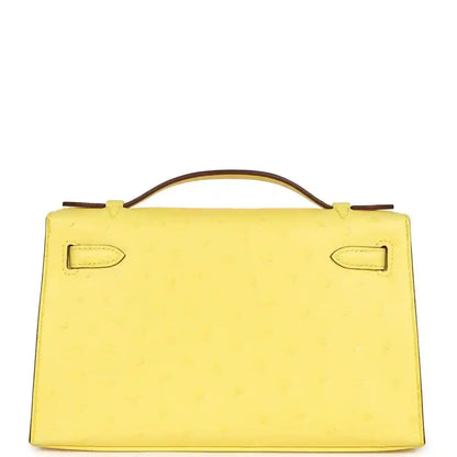 Yellow leather Kelly-style pochette back with top handle and stitched strap loops