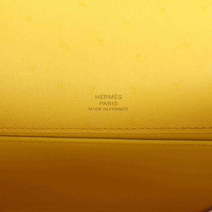 Yellow leather pochette with Hermes Paris and Made in France stamp detail