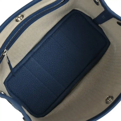 Blue and beige fabric-lined interior with zip pocket and divider