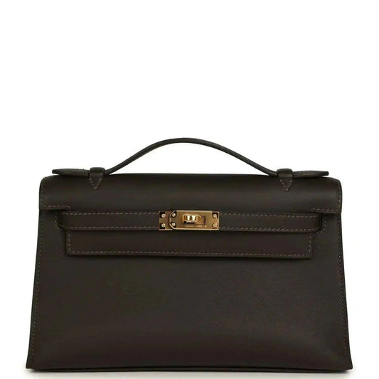 Dark brown leather pochette with gold-tone front clasp and top handle