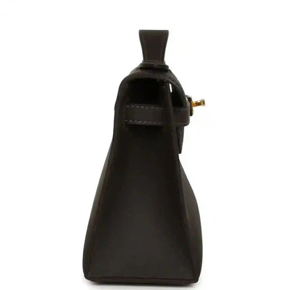Dark brown leather pochette side view with top opening and gold-tone clasp hardware