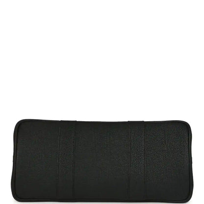Black leather interior pocket panel with rounded edges and stitched seams
