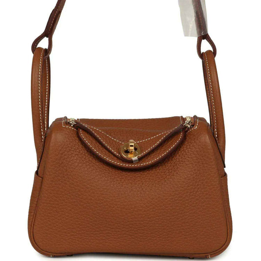 Mini Lindy bag in tan textured leather with gold-tone clasp and top handles