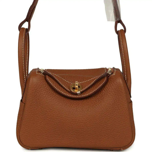 Mini Lindy bag in tan textured leather with gold-tone clasp and top handles