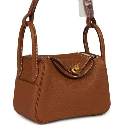 Mini Lindy bag in tan textured leather with gold-tone clasp and double top handles