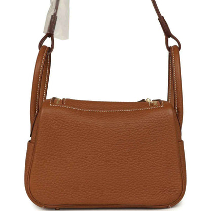 Mini Lindy bag in tan textured leather with top handles and stitched frame