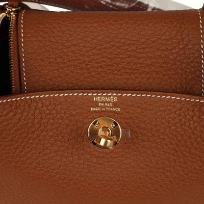 Hermes Mini Lindy bag in tan textured leather with gold-tone turn-lock and HERMES Paris