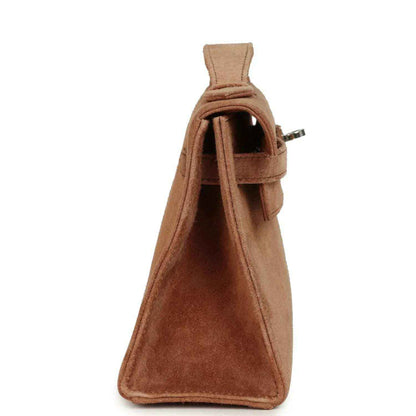 Hermès suede Kelly-style pochette side view with flap opening, fauve