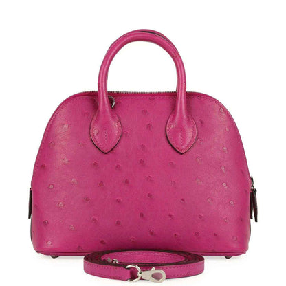 Mini Bolide bag in rose purple ostrich leather with top handles and crossbody strap.