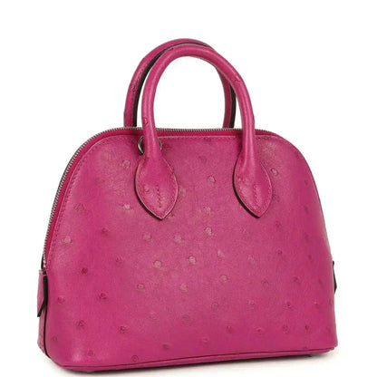 Mini Bolide bag in rose purple ostrich leather with top handles and zip opening.