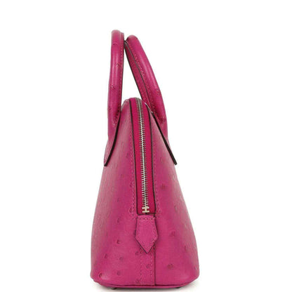 Mini Bolide bag side view in rose purple ostrich leather with central zipper.