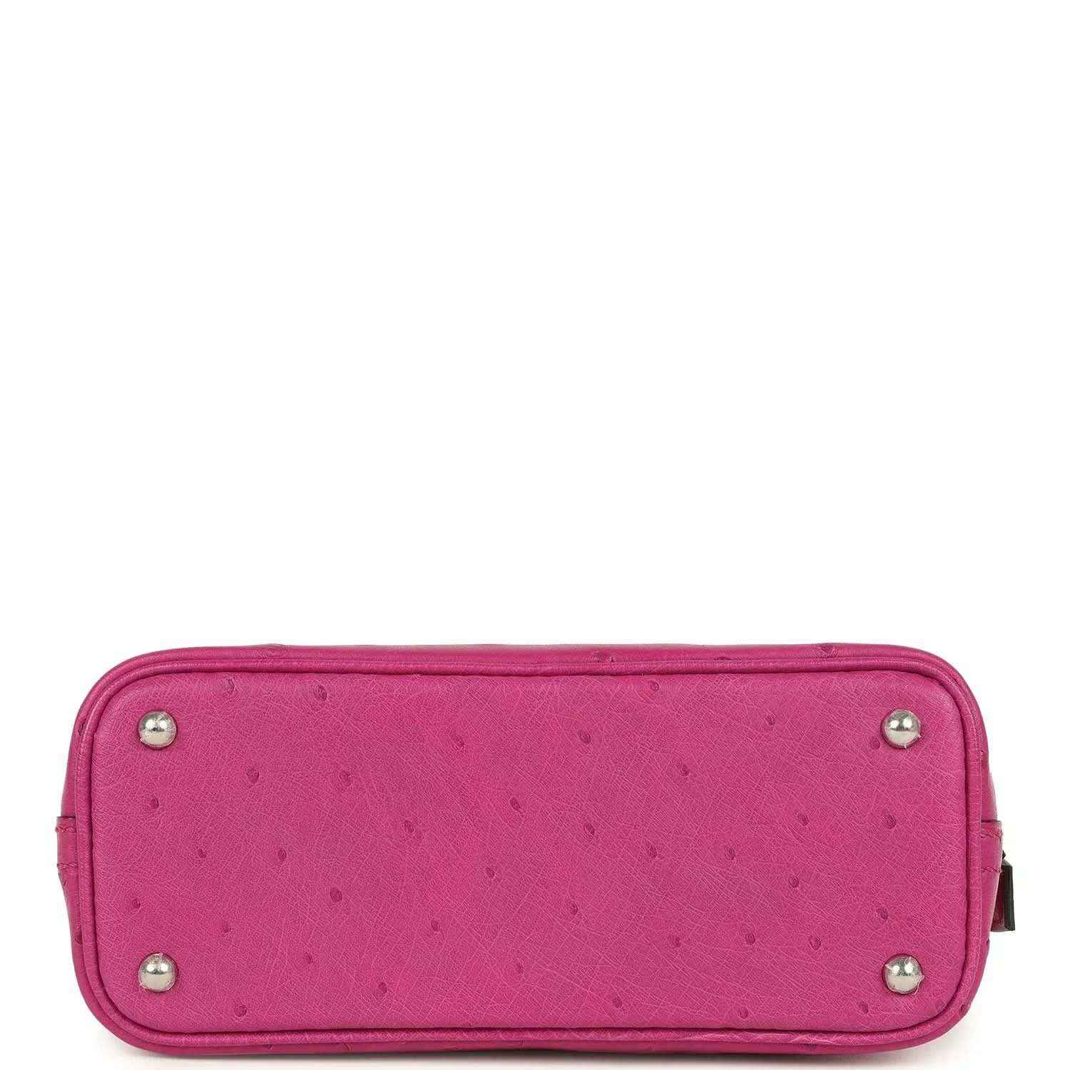 Mini Bolide bag bottom view in rose purple ostrich leather with corner feet studs.