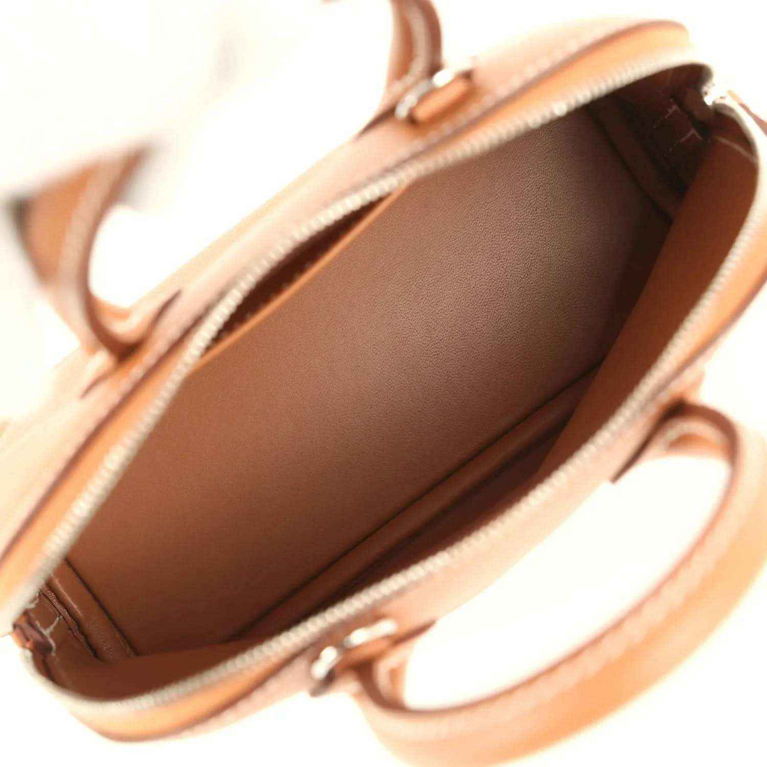Mini Bolide handbag interior with smooth brown lining and open top zipper edge
