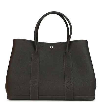 Leather tote bag with top handles and gold-tone clasp, dark brown, front panel.