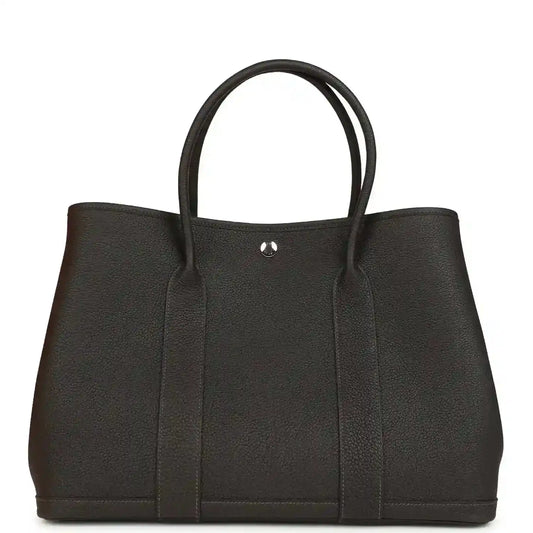 Leather tote bag with top handles and gold-tone clasp, dark brown, front panel.