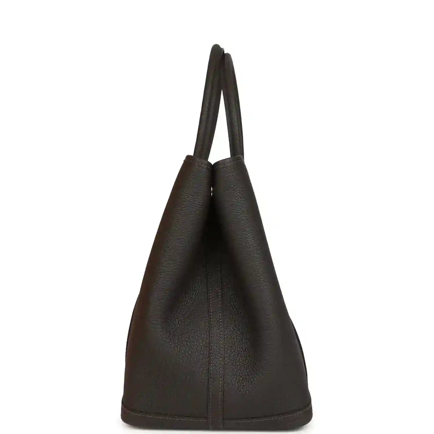 Leather tote bag side view with tall structure and top handles, dark brown.