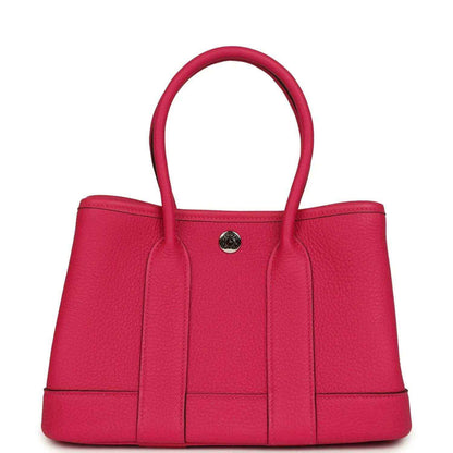 Rose pink leather tote bag with top handles and front decorative panel seams