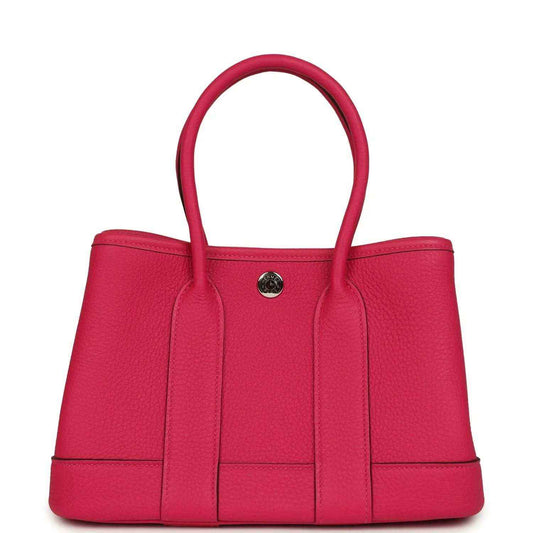 Rose pink leather tote bag with top handles and front decorative panel seams