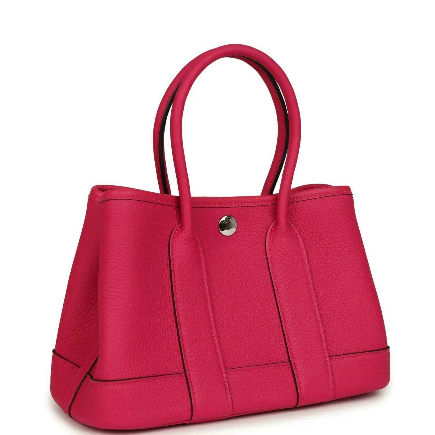 Rose pink leather tote bag with structured sides, top handles, and front center strap