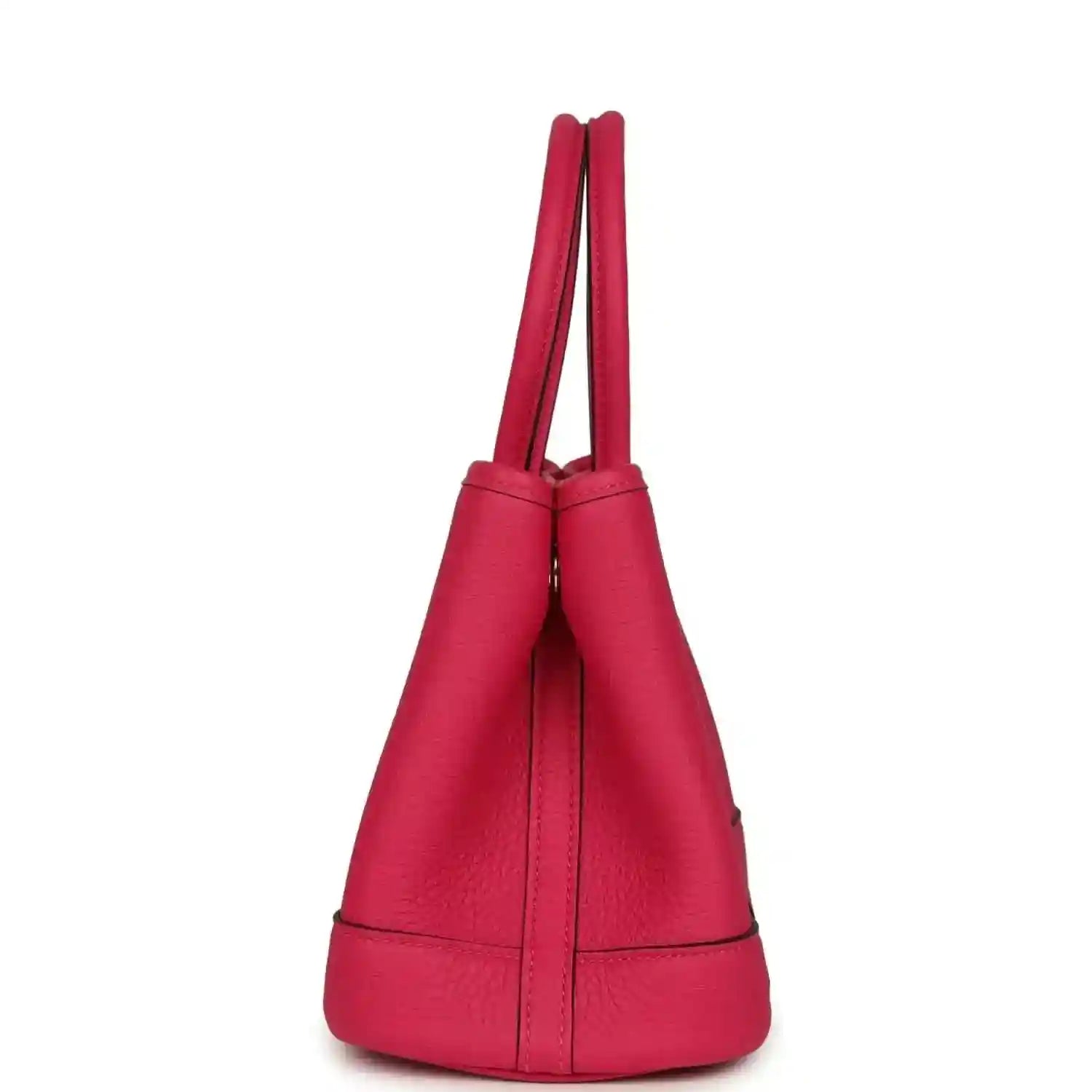Rose pink leather tote bag side view with two top handles and vertical seam panels