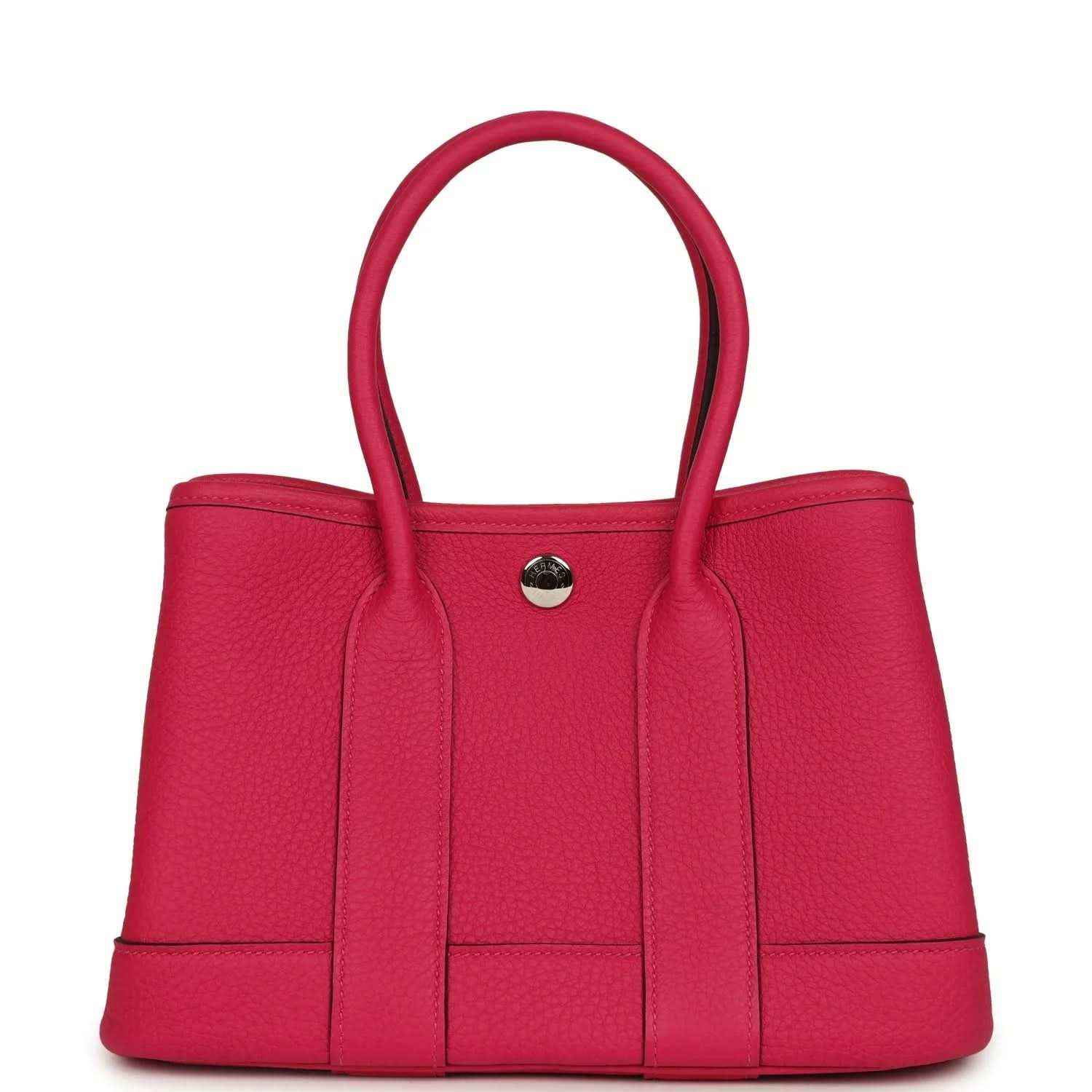 Rose pink leather tote bag with top handles and round metal front snap closure