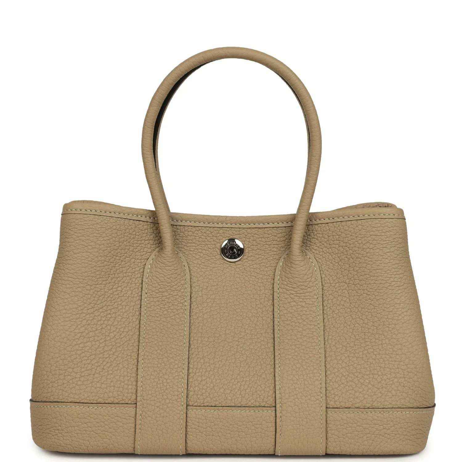 Trench-colored leather tote with top handles and round front snap closure