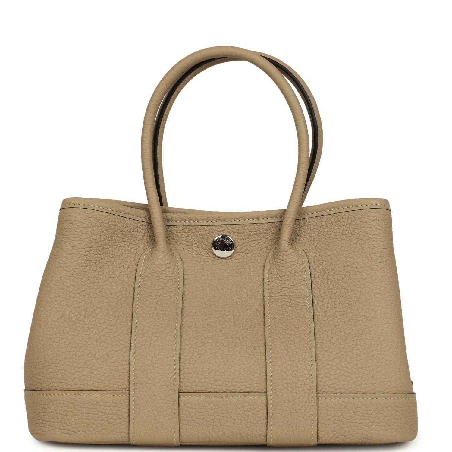 Trench leather tote with top handles and front button snap closure