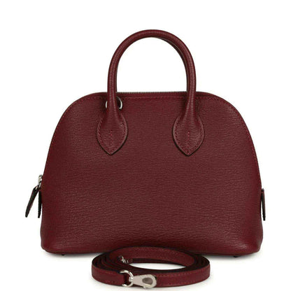 Mini leather handbag in deep red with top handles and detachable strap