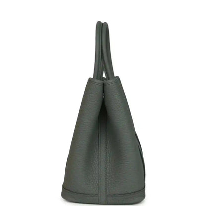 Leather tote bag with tall top handles and side profile, textured dark green