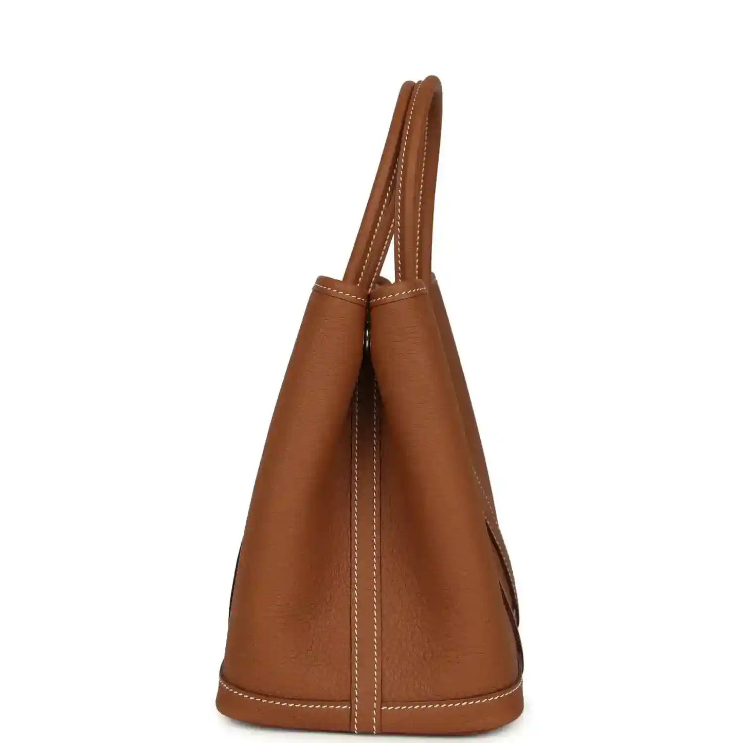 Brown leather tote bag shown from side with stitched trim and two handles