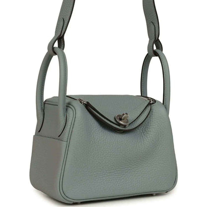 Mini leather handbag with dual handles and front flap, gray-green tone