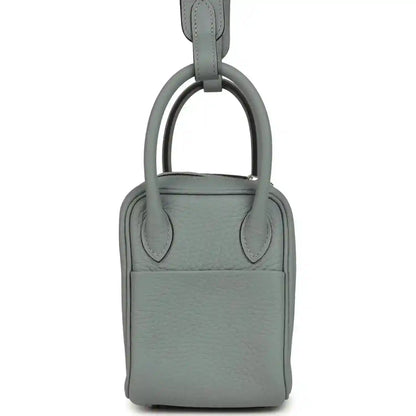 Mini leather handbag with top handle, front panel and magnetic clasp, gray-green