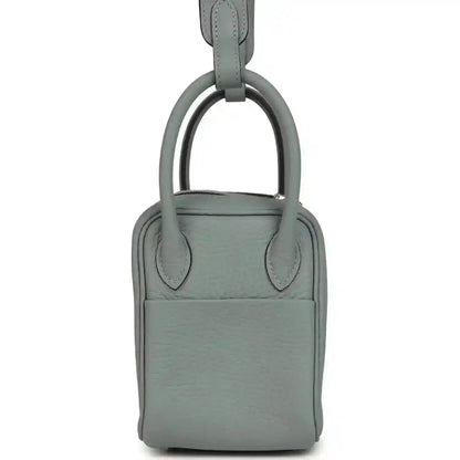 Mini leather handbag with top handle, front panel and magnetic clasp, gray-green