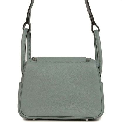 Mini leather handbag with structured body and front flap, gray-green tone